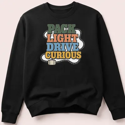 Bold retro Pack Light Drive Curious T-shirt with adventure theme in vibrant colors — printed on a unisex sweatshirt