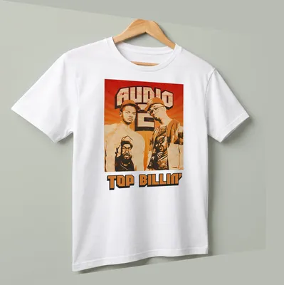 Retro distressed Audio Two Top Billin' T-shirt featuring two men in orange, brown, black, and white — printed on a unisex t-shirt (angled view)