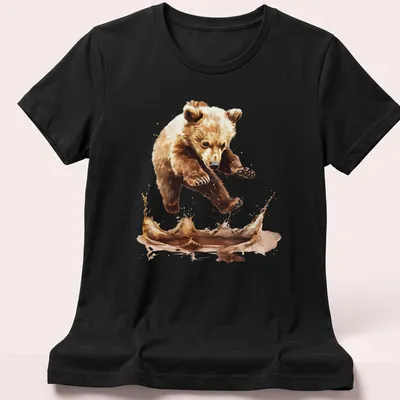 Watercolor splash t-shirt featuring a jumping bear cub in brown and cream tones — printed on a women's shirt