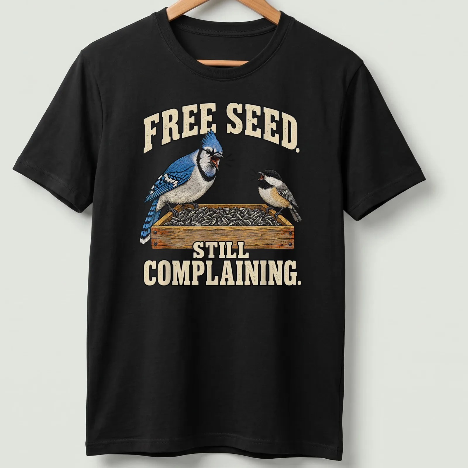 Illustration of a Blue Jay with humorous text about free seeds — printed on a unisex t-shirt