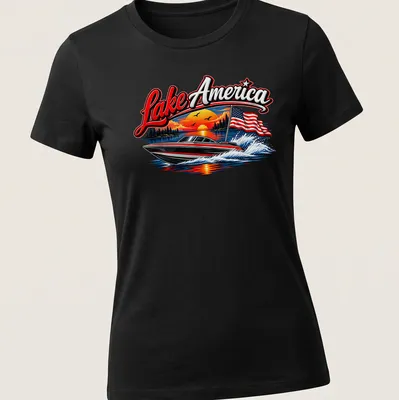 Vibrant t-shirt featuring a boat on Lake America with a sunset and American flag — printed on a women's shirt