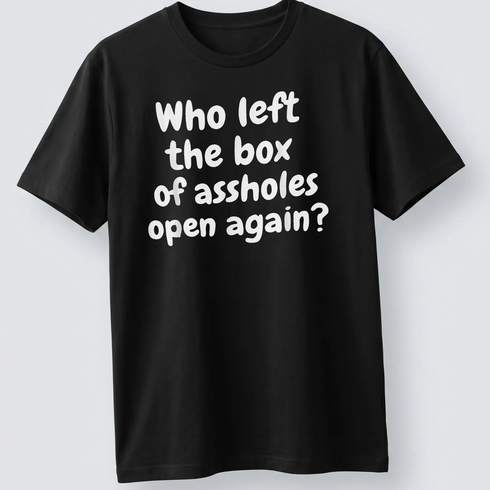 Funny T-shirt with text asking who left the box of assholes open again, against a white background. — printed on a unisex t-shirt