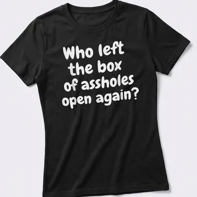 Funny T-shirt with text asking who left the box of assholes open again, against a white background. — printed on a women's shirt