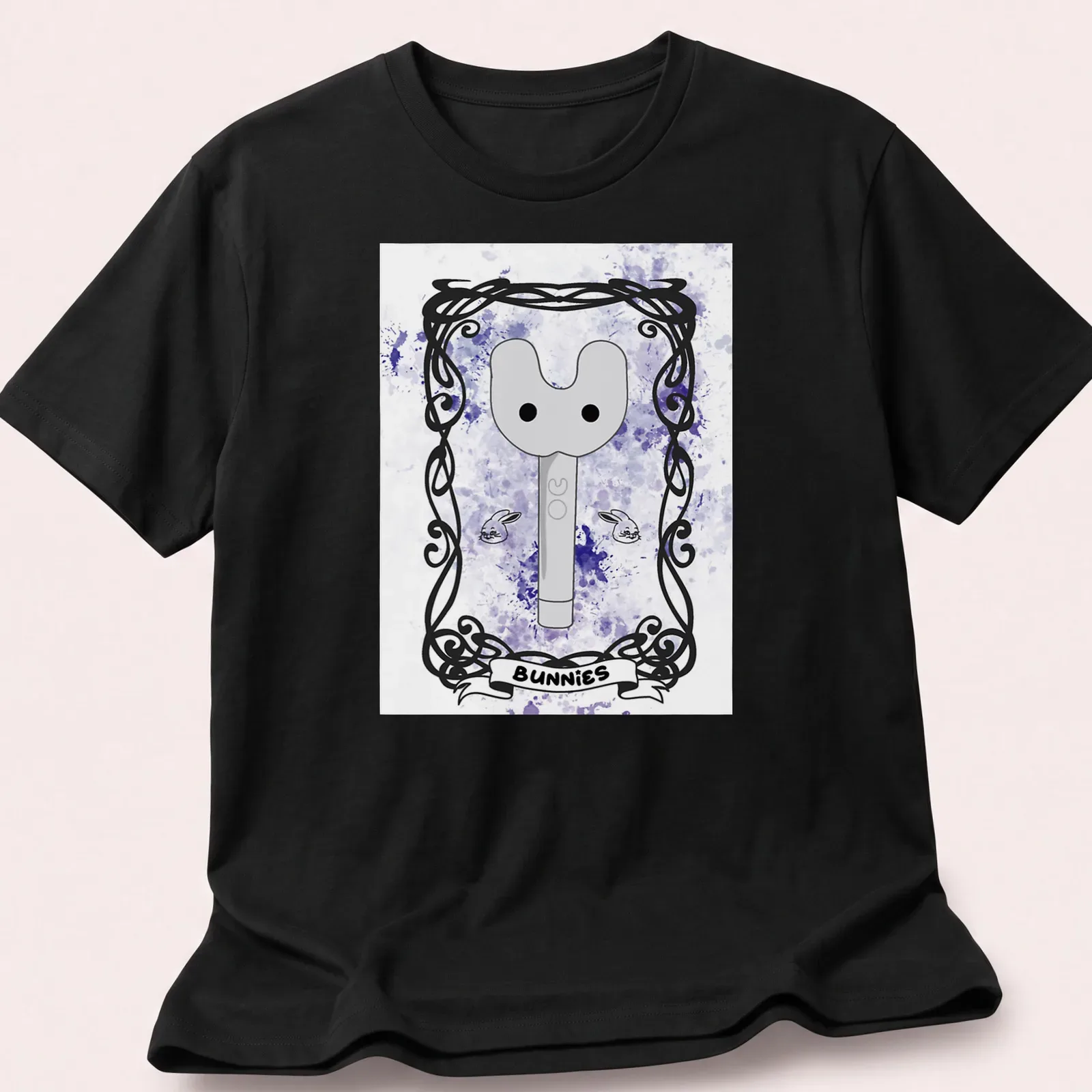 Whimsical illustration of a key-like character with 'BUNNIES' text in purple and gray tones — printed on a unisex t-shirt