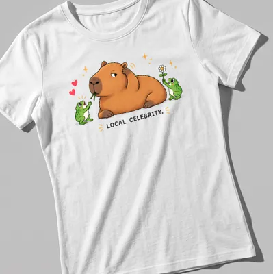 Kawaii style capybara surrounded by frog fans with text 'LOCAL CELEBRITY.' — printed on a women's shirt