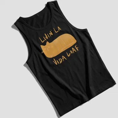 Kawaii illustration of a loafing cat with text 'Livin' La Vida Loaf' in orange and cream. — printed on a tank top