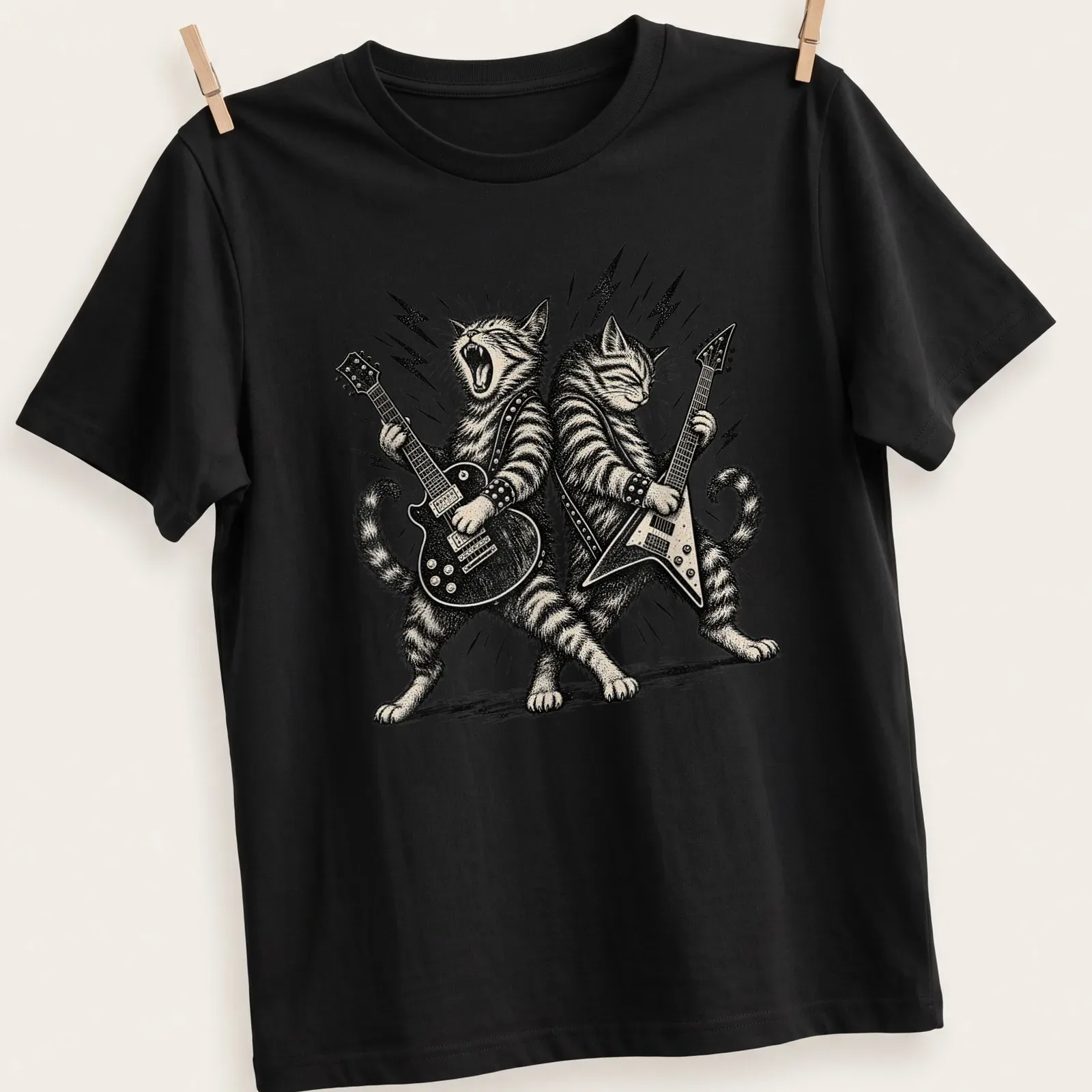 Two illustrated cats playing guitars in vintage rock style on a T-shirt. — printed on a unisex t-shirt