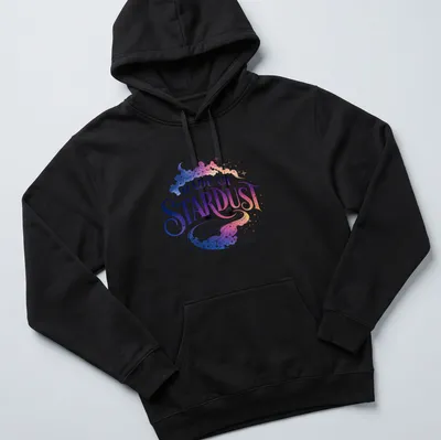 Celestial galaxy design with text 'MADE OF STARDUST' in purple, blue, pink, and white — printed on a unisex hoodie