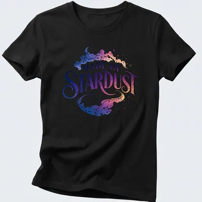 Celestial galaxy design with text 'MADE OF STARDUST' in purple, blue, pink, and white — printed on a women's shirt