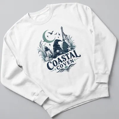 Vintage illustrated Coastal Coven t-shirt with witch hat and coastal motifs — printed on a unisex sweatshirt