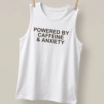 Bold typography t-shirt with the phrase 'Powered By Caffeine & Anxiety' in brown — printed on a tank top