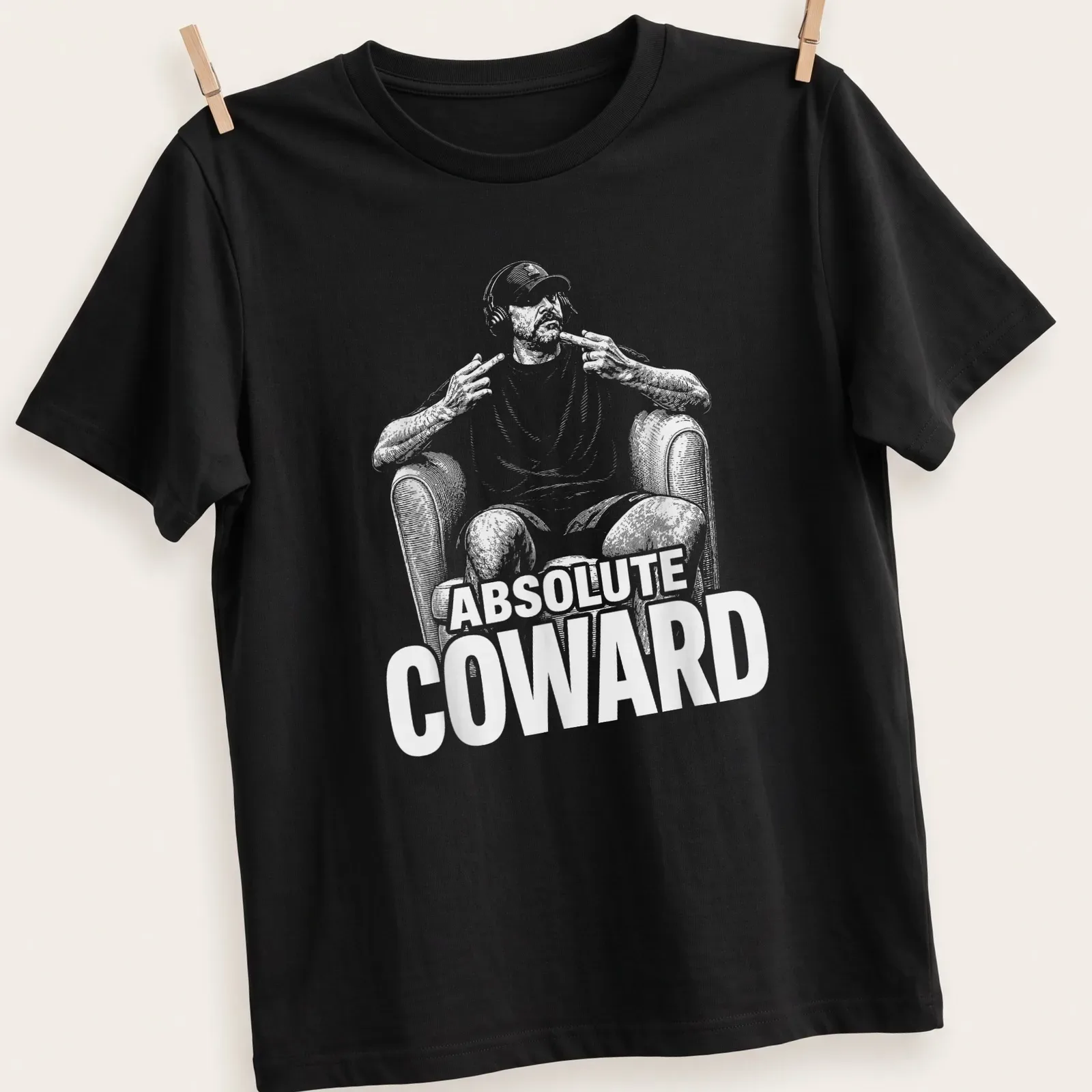 Humorous illustration of a person with headphones and text reading Absolute Coward — printed on a unisex t-shirt
