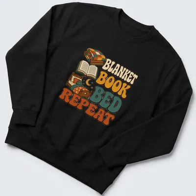 Retro graphic tee with plaid blanket, open book, and bed design — printed on a unisex sweatshirt