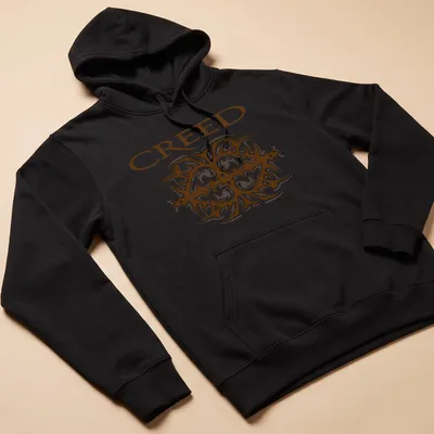 Ornate printed design of the Creed band logo in brown and white — printed on a unisex hoodie