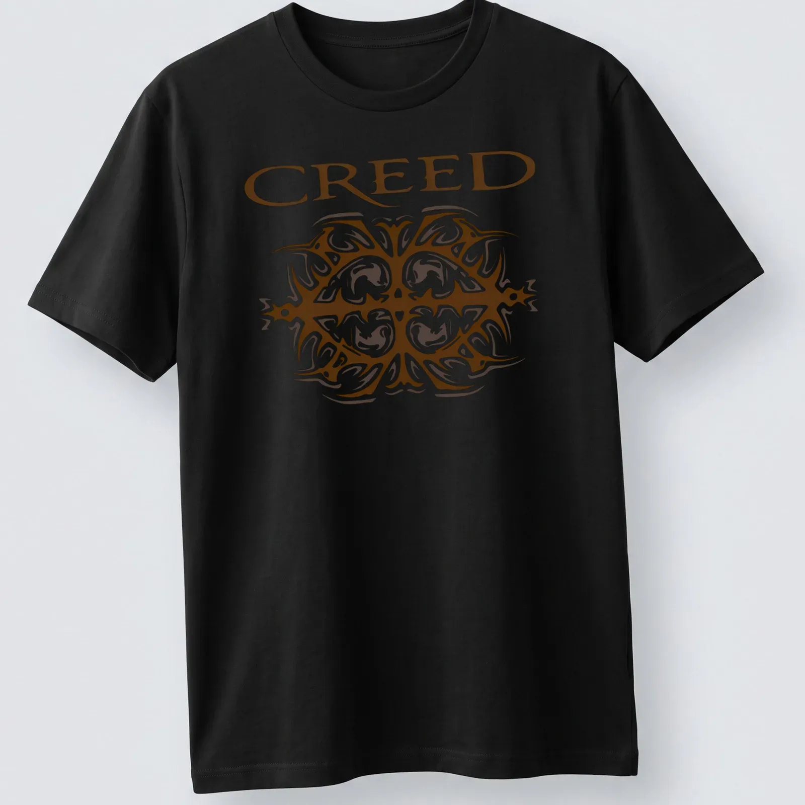 Ornate printed design of the Creed band logo in brown and white — printed on a unisex t-shirt