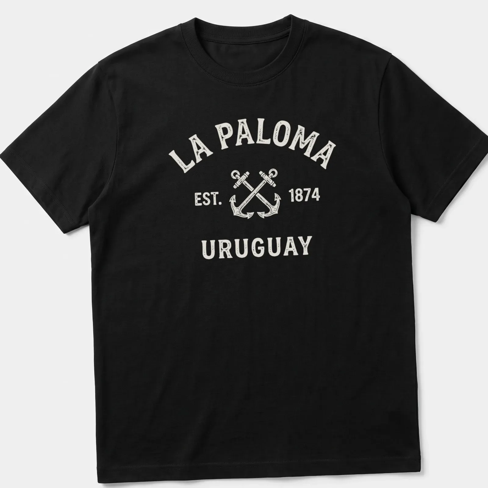 Vintage design with crossed boat anchors and La Paloma text in cream and light beige. — printed on a unisex t-shirt