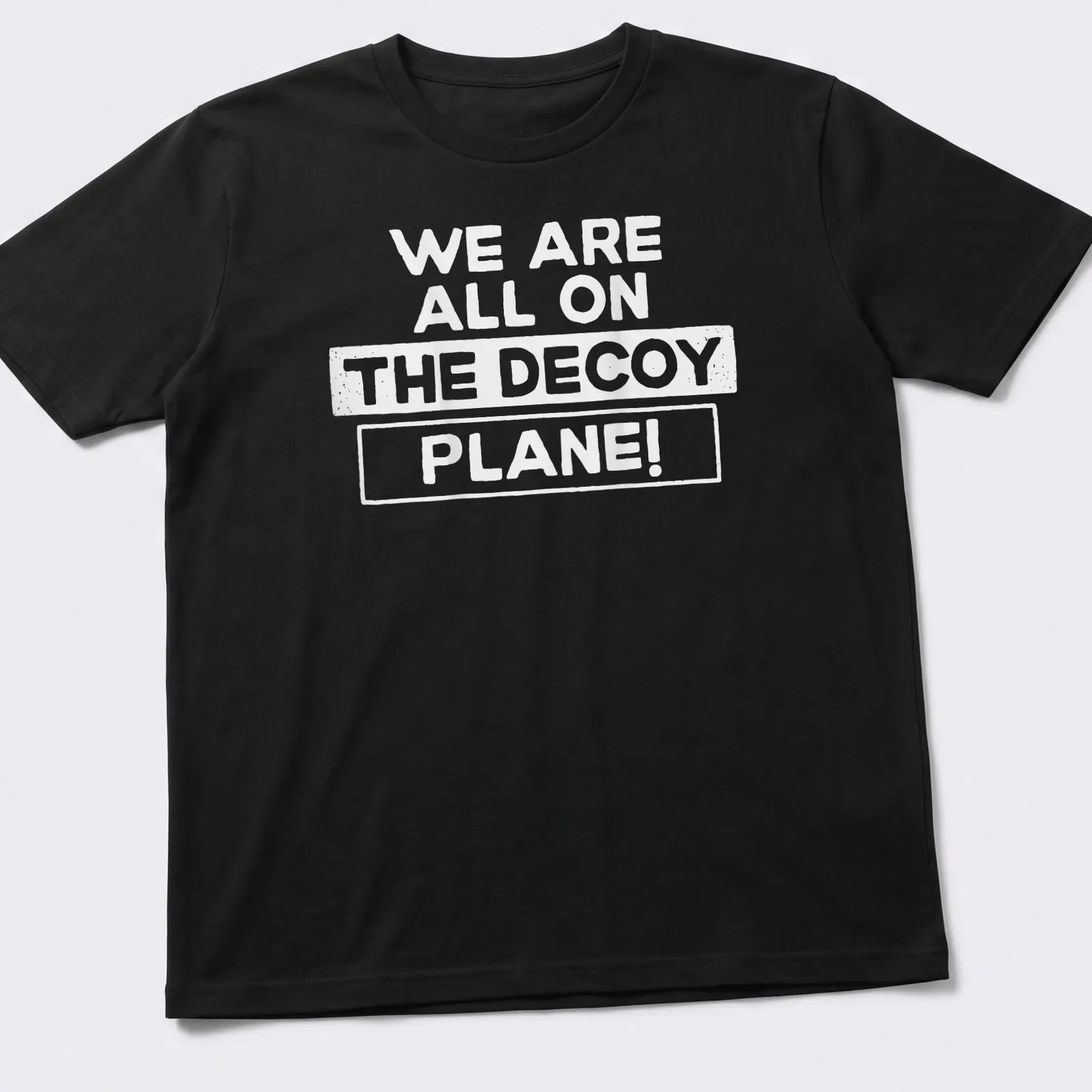 Bold typography tee with the phrase We Are All On The Decoy Plane! — printed on a unisex t-shirt