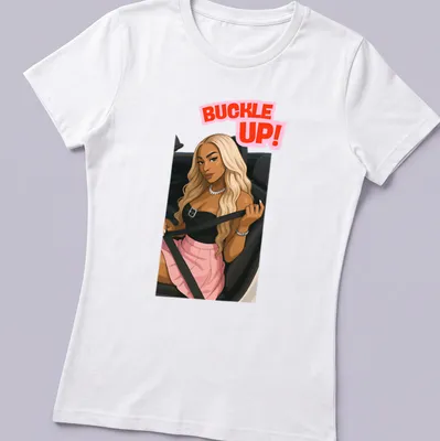 Kawaii line-art of Dijonai Carrington with 'Buckle Up!' text in pink and black — printed on a women's shirt