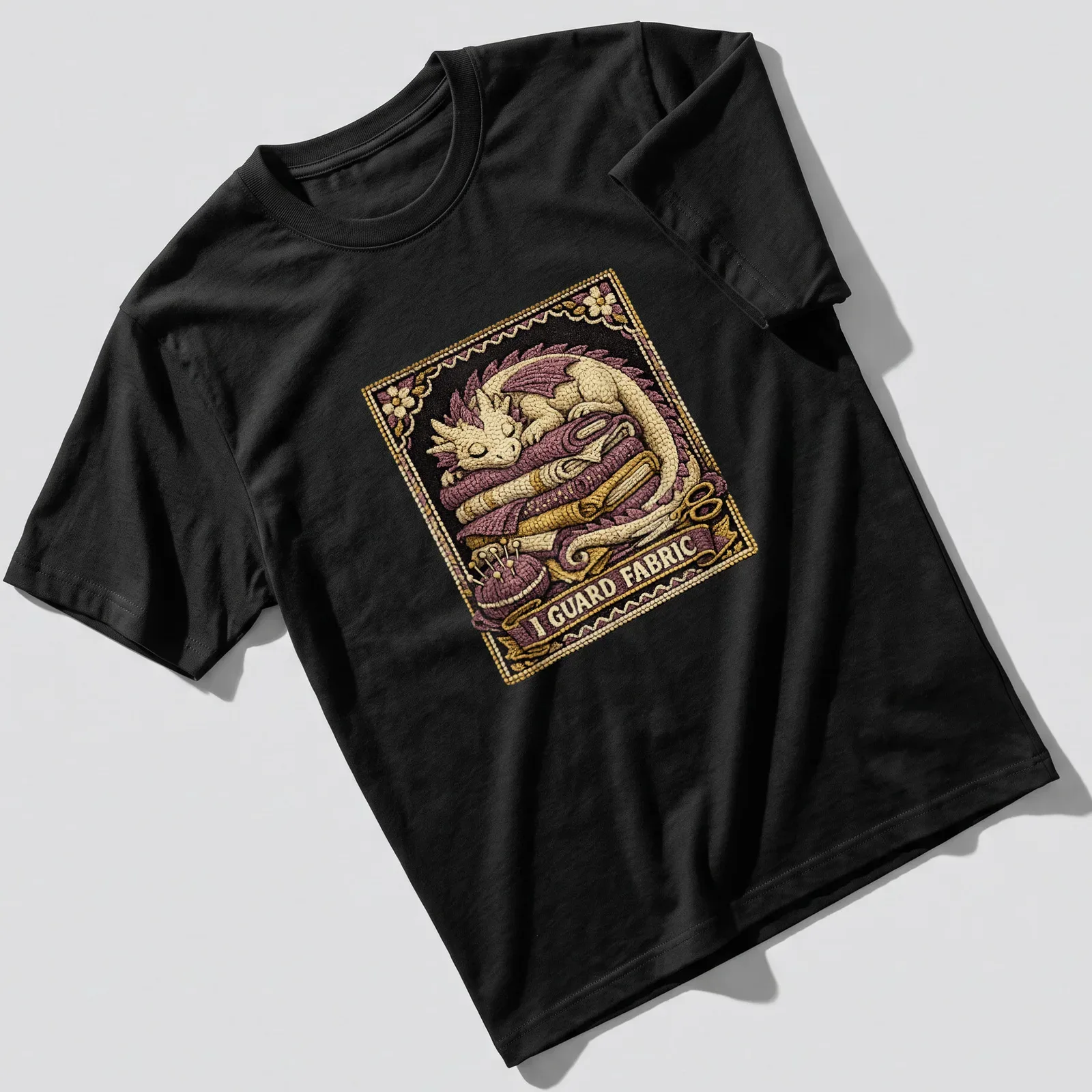 Detailed illustration of a dragon guarding the phrase 'I GUARD FABRIC' in purple and gold — printed on a unisex t-shirt