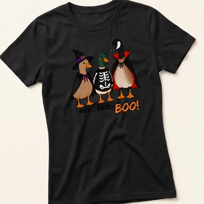 Cartoon ducks in costumes with the text Duck Duck Boo! in vibrant colors. — printed on a women's shirt