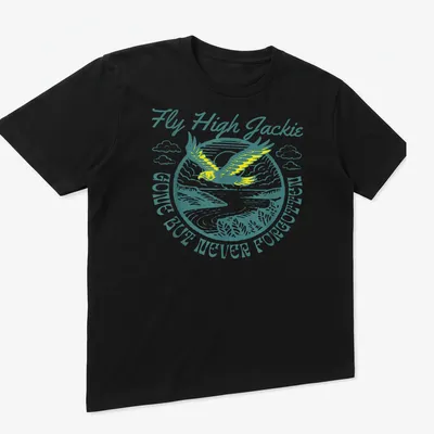 Vintage illustration of an eagle with text 'Fly High Jackie GONE BUT NEVER FORGOTTEN' in teal and yellow — printed on a unisex t-shirt (angled view)