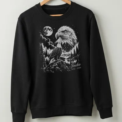 Detailed illustration of an eagle in flight with memorial text below. — printed on a unisex sweatshirt