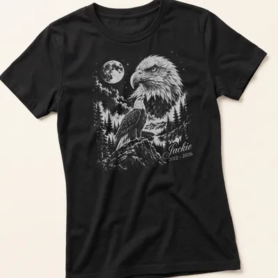 Detailed illustration of an eagle in flight with memorial text below. — printed on a women's shirt