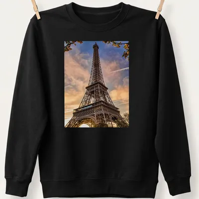 Photographic print of the Eiffel Tower in golden, blue, pink, and orange hues — printed on a unisex sweatshirt