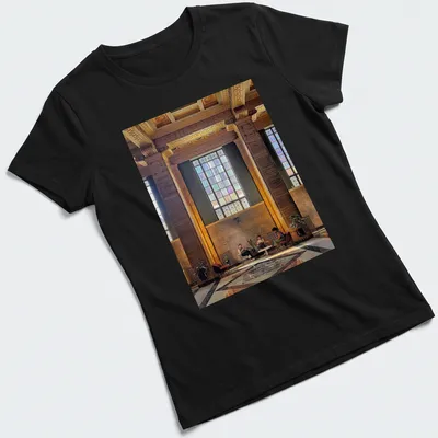 Modern architectural print of an interior scene with people in gold, brown, green, blue, and purple — printed on a women's shirt