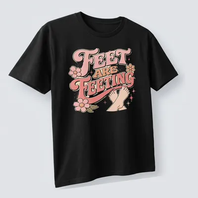 Playful retro Feet Are Feeting t-shirt with colorful lettering and feet illustration — printed on a unisex t-shirt (angled view)