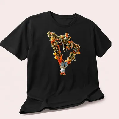 Vintage floral design with the text 'The Devil Wears Prada' in a playful style. — printed on a unisex t-shirt (angled view)
