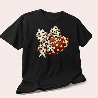 Realistic football with a polka dot bow graphic in brown and cream — printed on a unisex t-shirt (angled view)