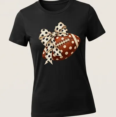 Realistic football with a polka dot bow graphic in brown and cream — printed on a women's shirt