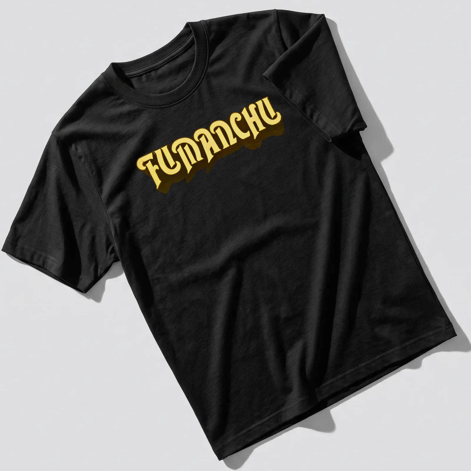 Bold yellow FUMANCHU text in heavy serif font on dark background — printed on a unisex t-shirt