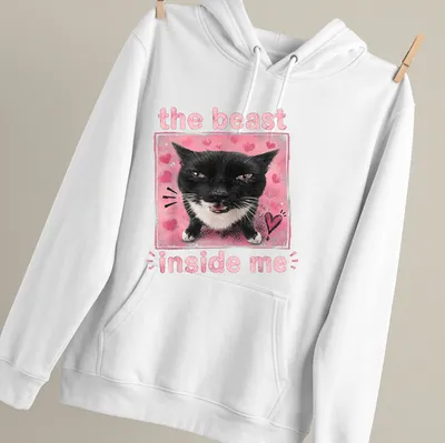 Illustration of a black and white cat with text 'the beast inside me' in playful font. — printed on a unisex hoodie