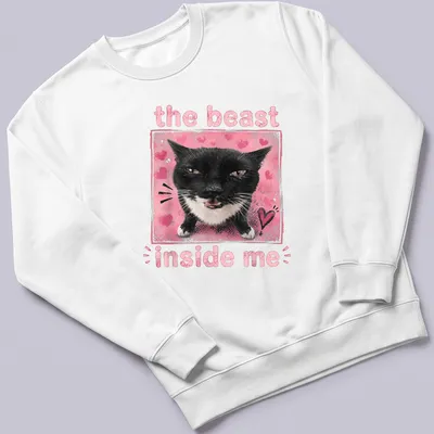 Illustration of a black and white cat with text 'the beast inside me' in playful font. — printed on a sweatshirt