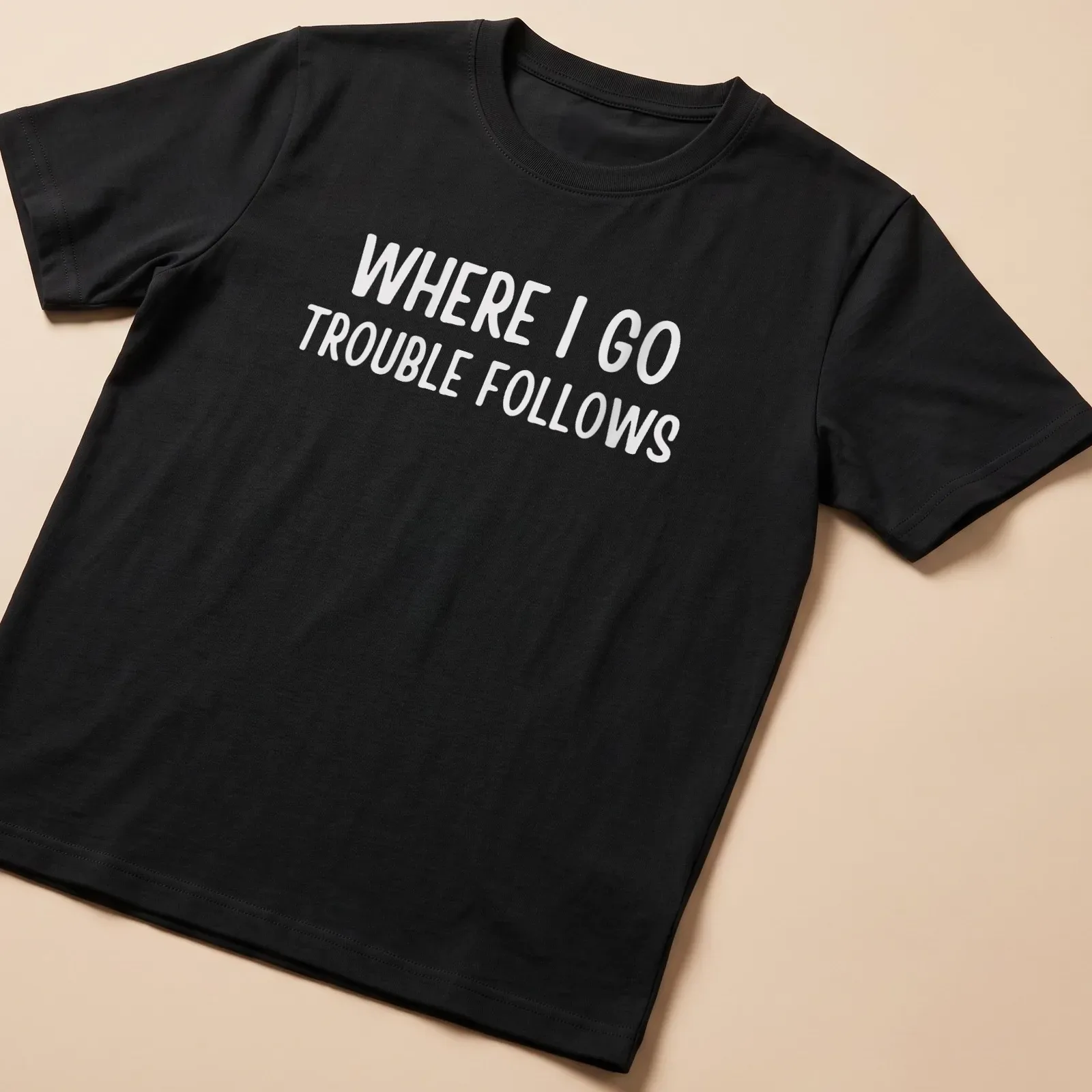 Bold typography on a white shirt reading 'Where I Go Trouble Follows' — printed on a unisex t-shirt