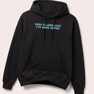 Light blue t-shirt with bold text reading 'Does it look like I've been crying' in a playful font. — printed on a unisex hoodie