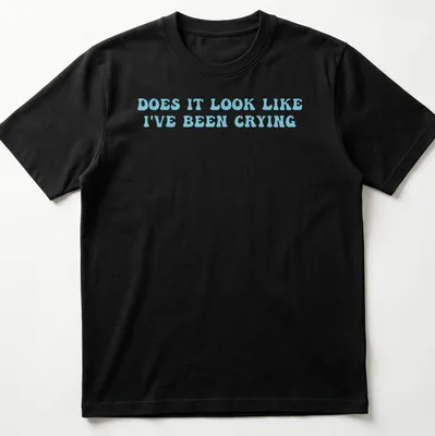 Light blue t-shirt with bold text reading 'Does it look like I've been crying' in a playful font. — printed on a unisex t-shirt