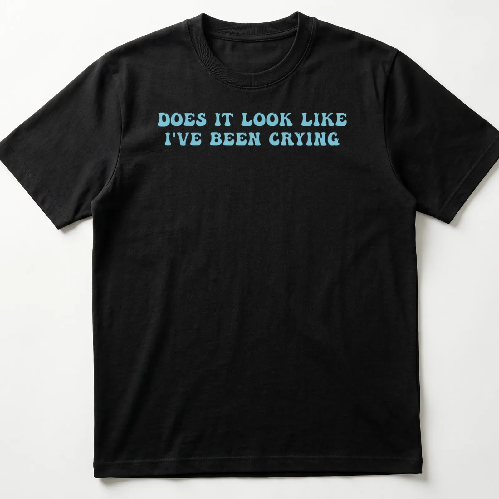 Light blue t-shirt with bold text reading 'Does it look like I've been crying' in a playful font. — printed on a unisex t-shirt
