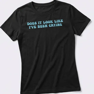 Light blue t-shirt with bold text reading 'Does it look like I've been crying' in a playful font. — printed on a women's shirt