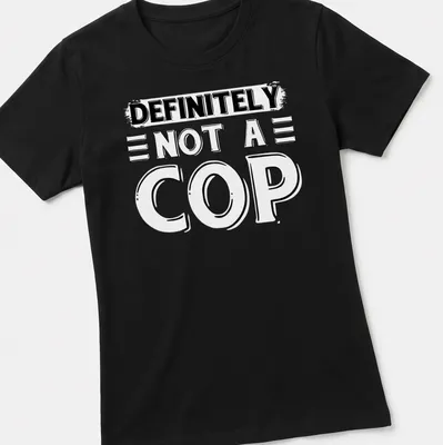 Bold typography shirt stating 'DEFINITELY NOT A COP' in black and white — printed on a women's shirt