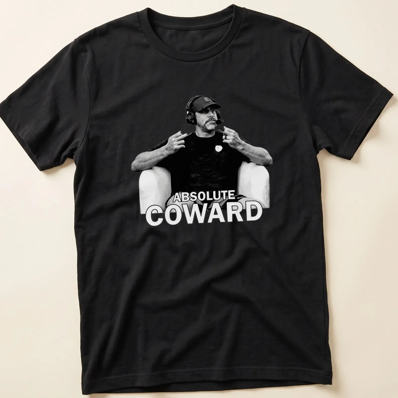 Black and white t-shirt featuring the text Absolute Coward with a sports commentator graphic — printed on a unisex t-shirt