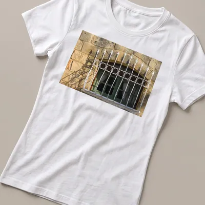 Realistic green arched window t-shirt with white wrought iron bars — printed on a women's shirt