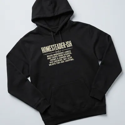 Vintage distressed shirt with humorous homesteader definition text — printed on a unisex hoodie