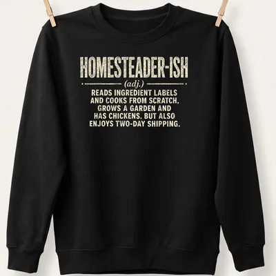 Vintage distressed shirt with humorous homesteader definition text — printed on a unisex sweatshirt