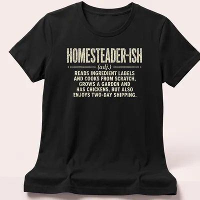 Vintage distressed shirt with humorous homesteader definition text — printed on a women's shirt