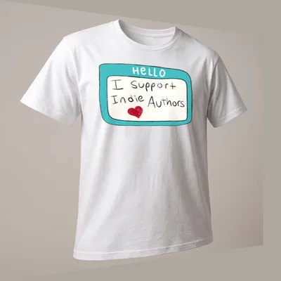 Playful name tag design with text 'I Support Indie Authors' in turquoise and red — printed on a unisex t-shirt (angled view)