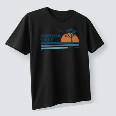 Retro distressed Joshua Tree t-shirt with vintage lettering and colors. — printed on a unisex t-shirt (angled view)