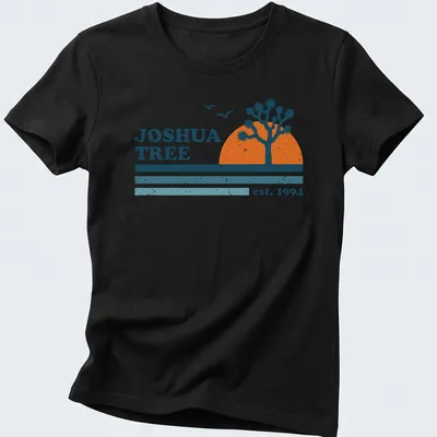Retro distressed Joshua Tree t-shirt with vintage lettering and colors. — printed on a women's shirt